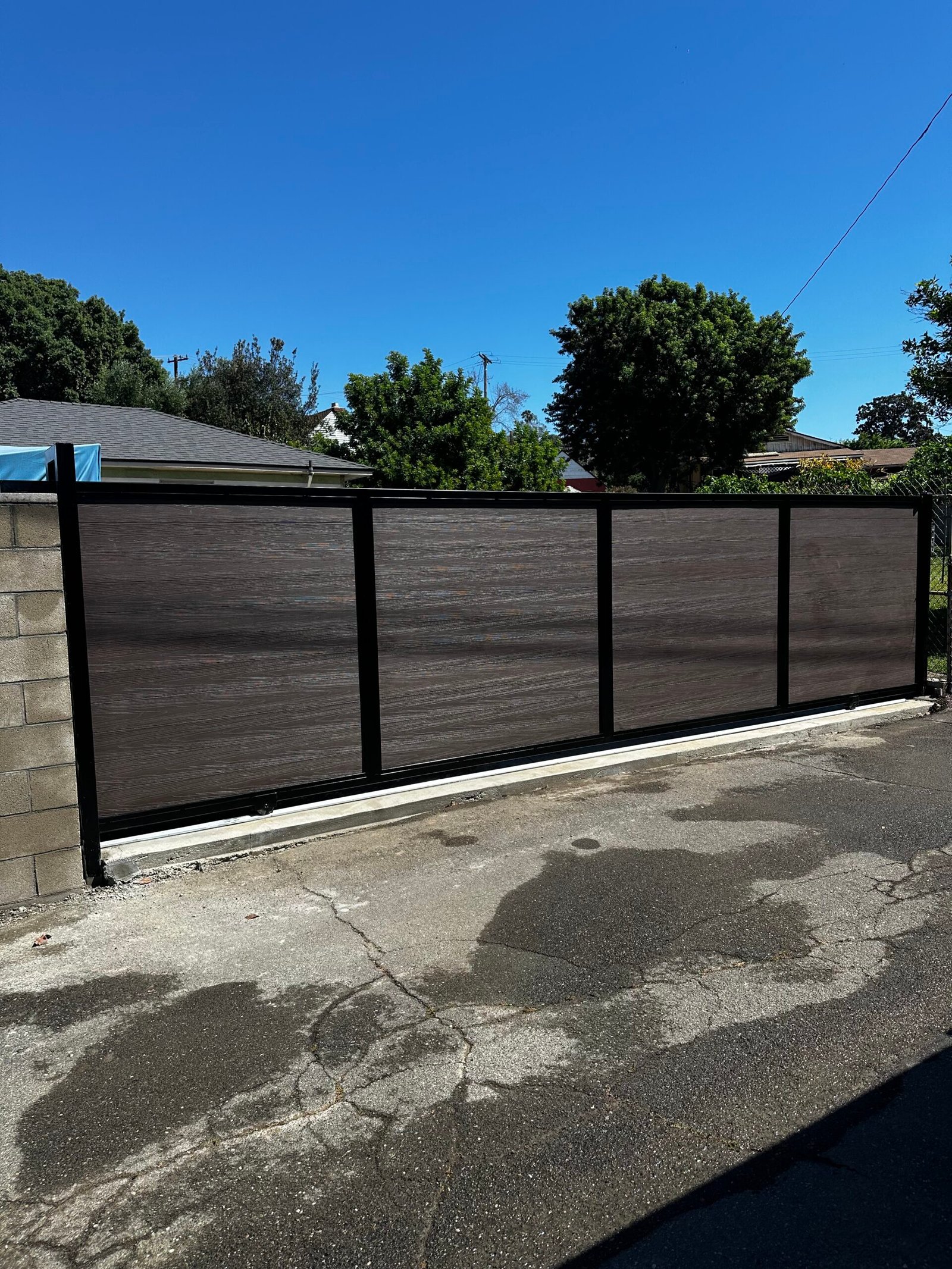 Custom welded iron entry gate fabricated and installed by Elite Hardscape Inc. in Southern California